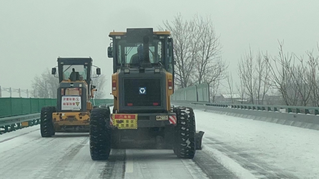 2月21日，六安西中心除雪小組在周集往南照方向用裝載機進行梯隊除雪作業.jpg